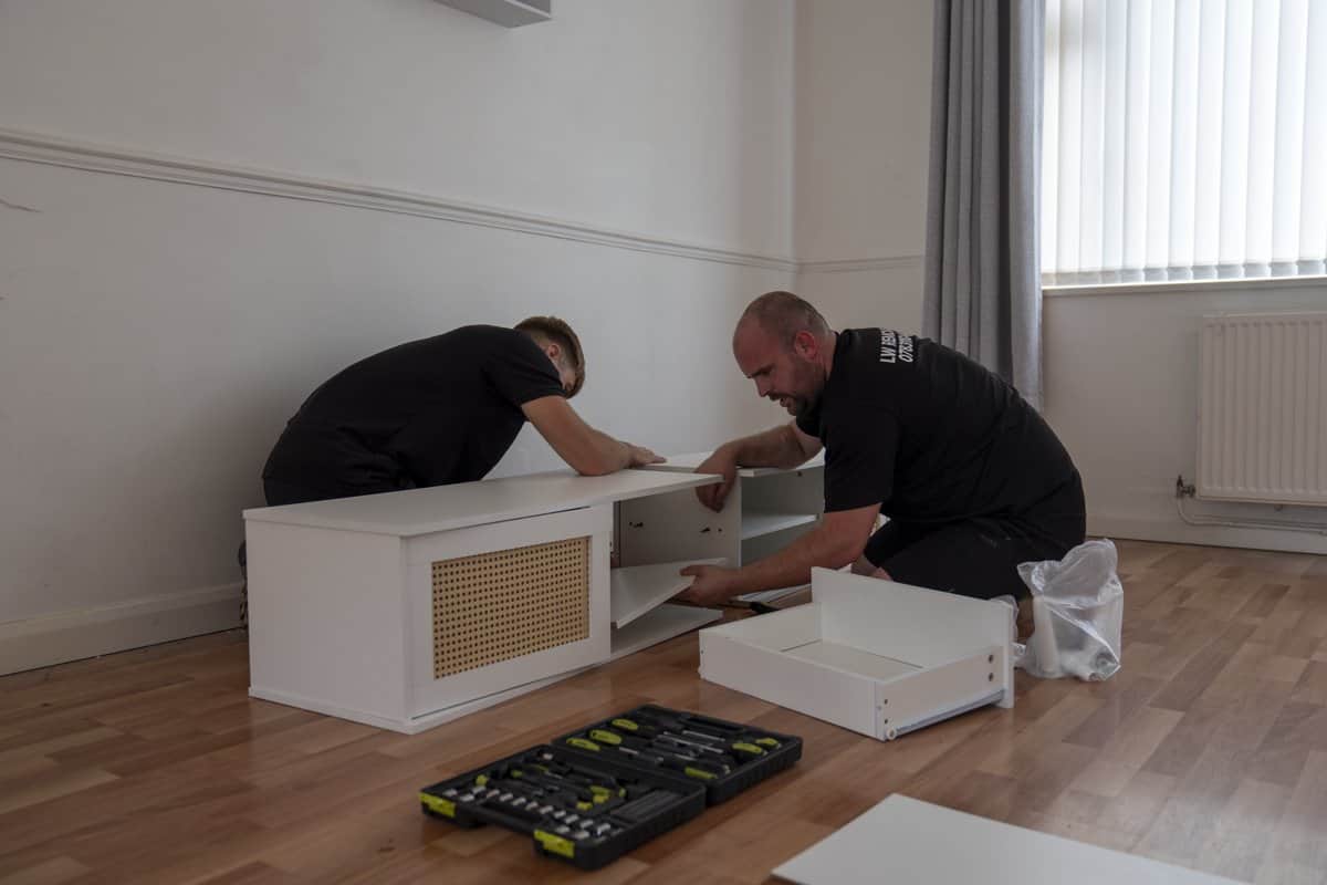 LW Removals team loading furniture into a removal van outside a house